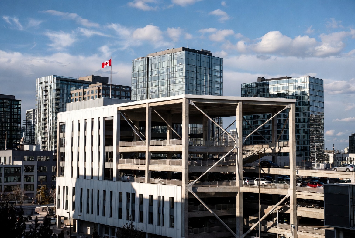 Canadian urban cityscape with modern parking structure and Canadian flag