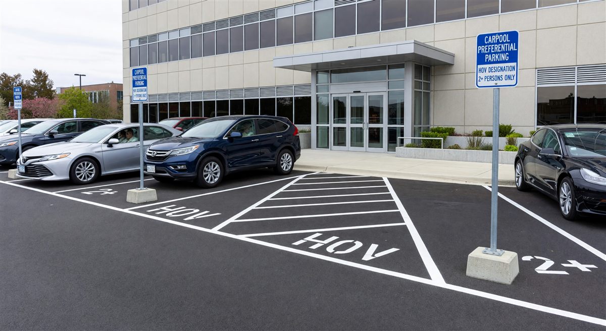 Carpool preferential parking stalls near building entrance with HOV designation signs