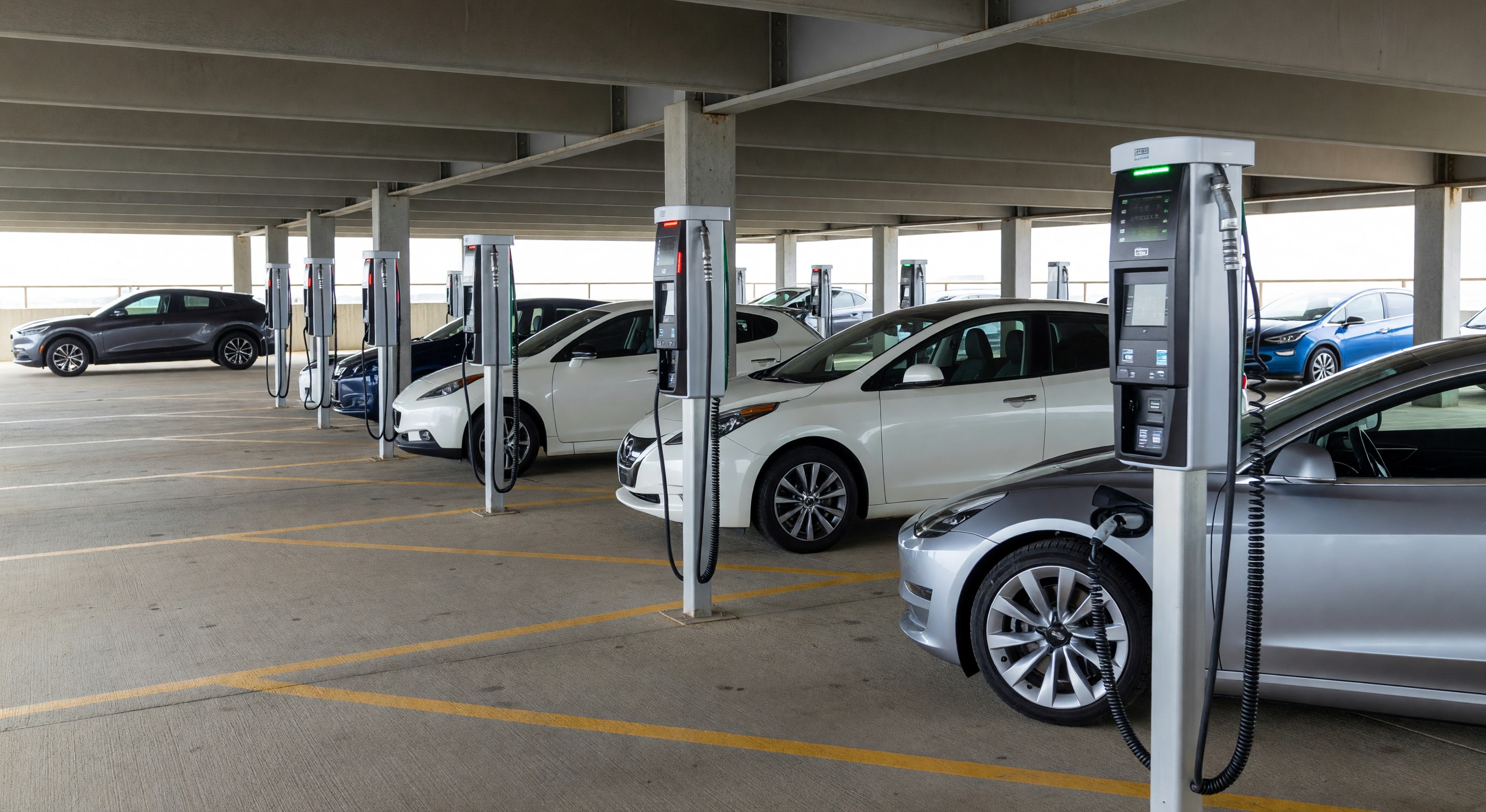 Electric vehicle charging at parking facility with multiple Level 2 EVSE units in covered parking structure