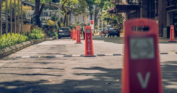Luxury hotel entrance with valet parking area and parking equipment