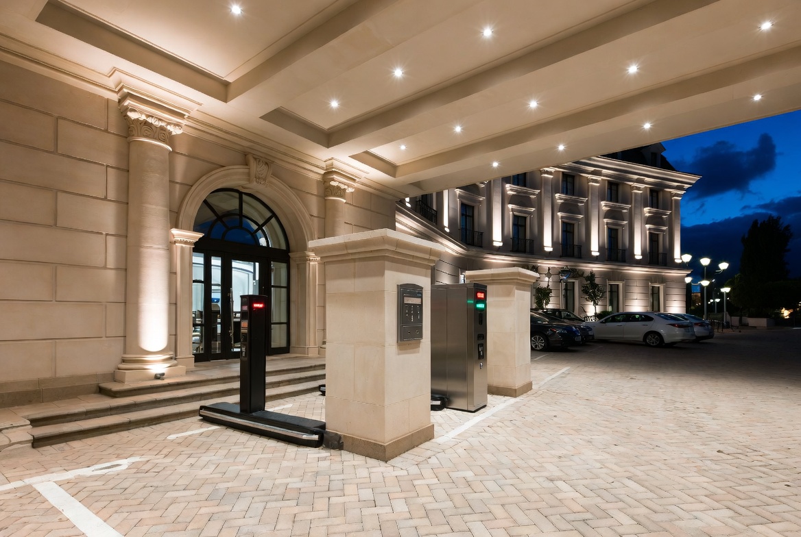 Luxury hotel entrance with valet parking area and parking equipment