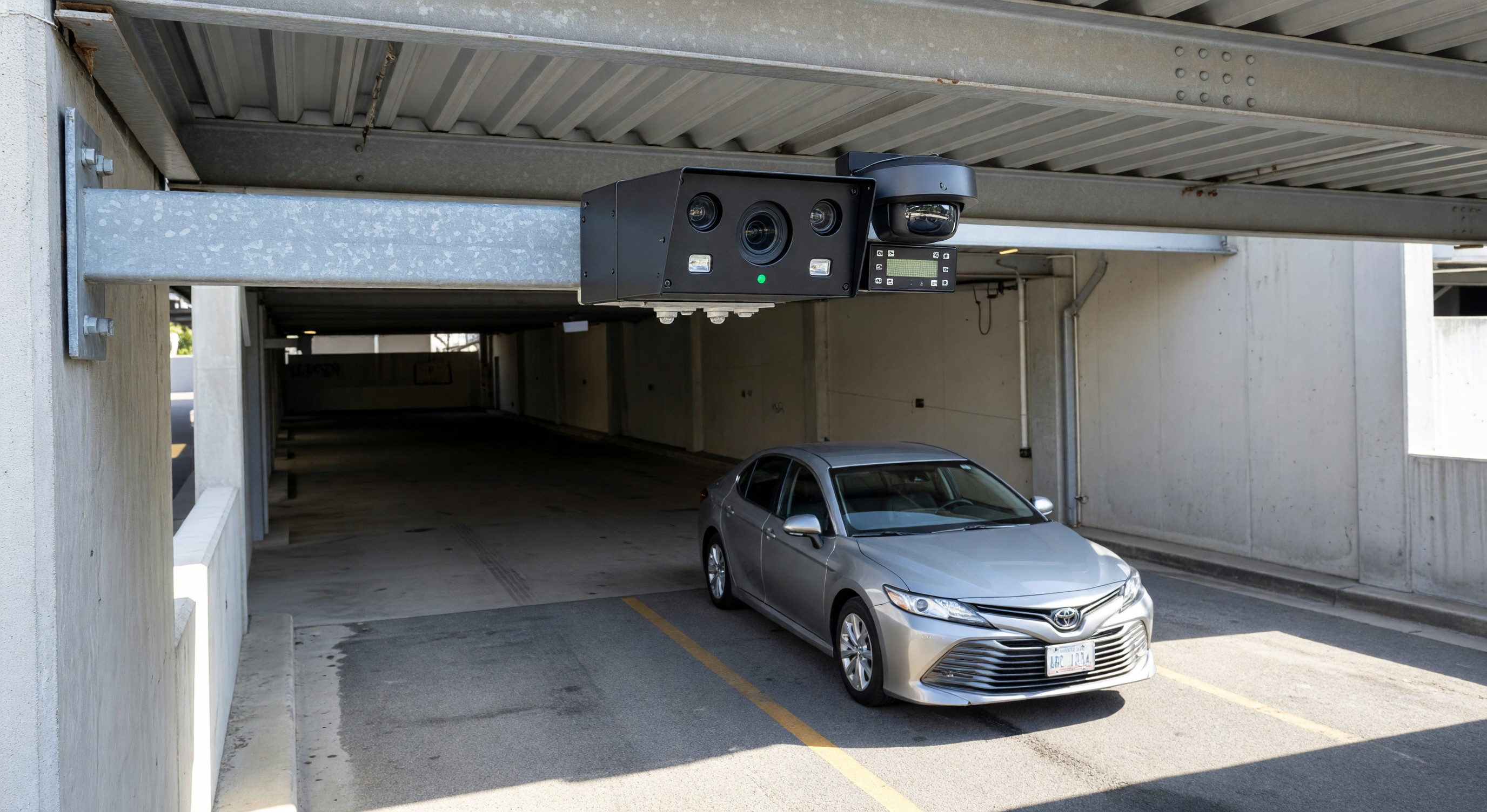 License plate recognition camera mounted at parking facility entrance capturing vehicle plate