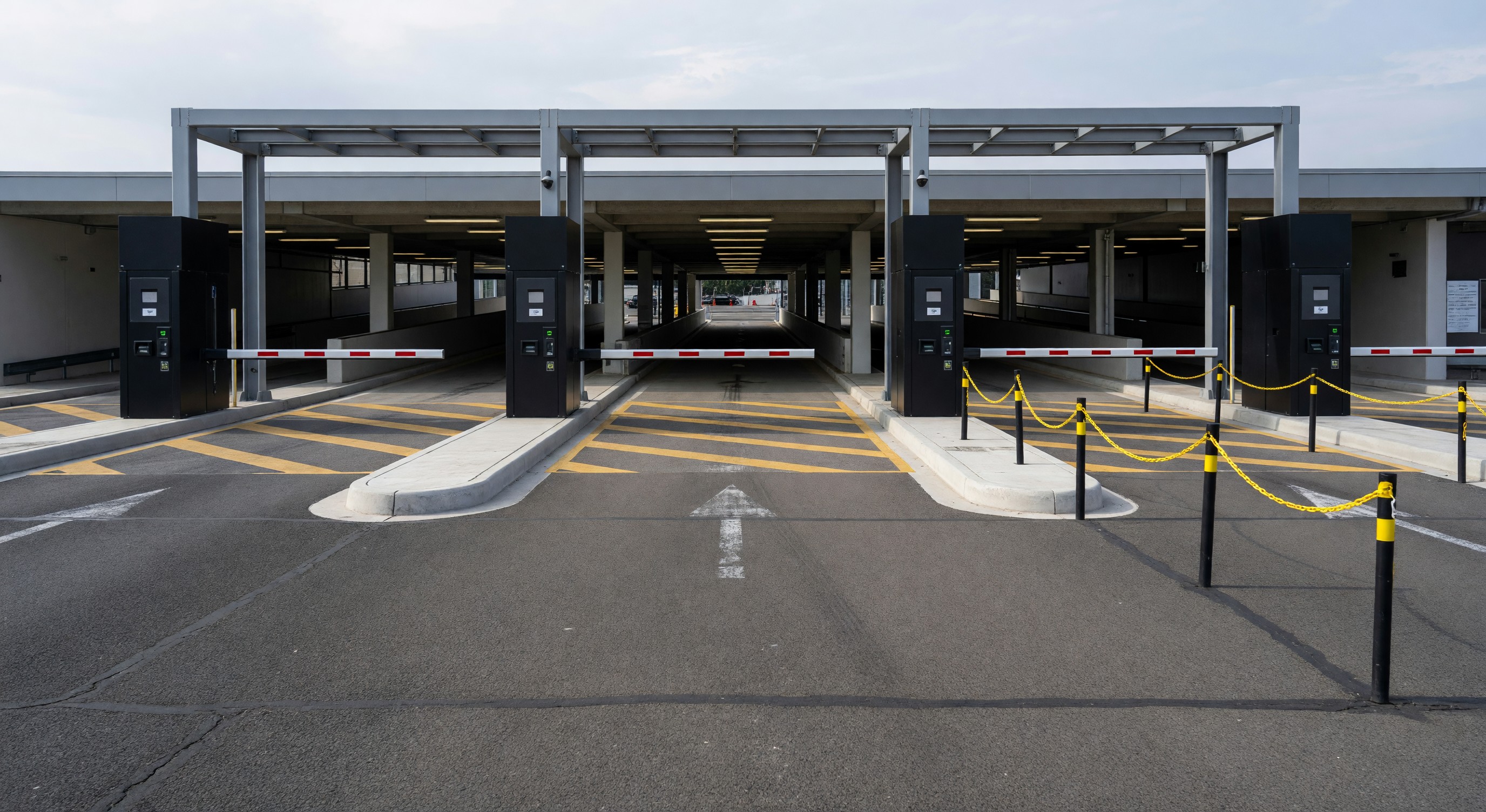 Parking facility entry with multiple lanes and queuing area before the gate equipment