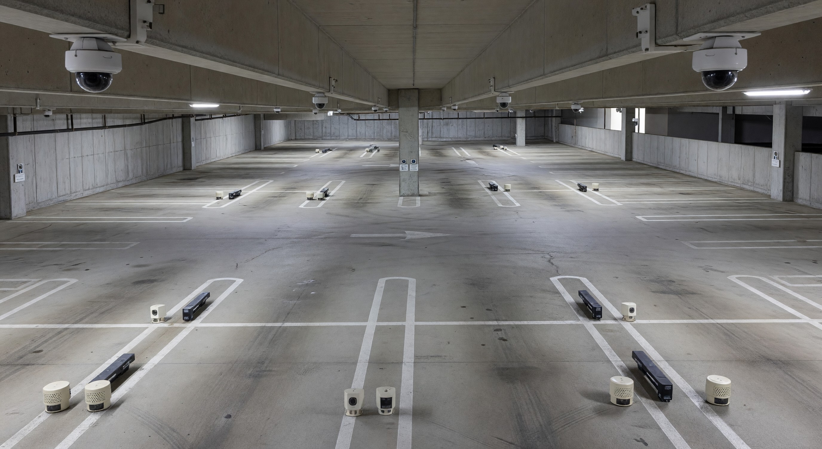 Overhead view of parking structure showing various sensor types mounted on ceiling and walls