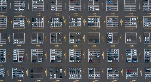Aerial view of a well-organized parking lot with clear aisle markings and stall lines