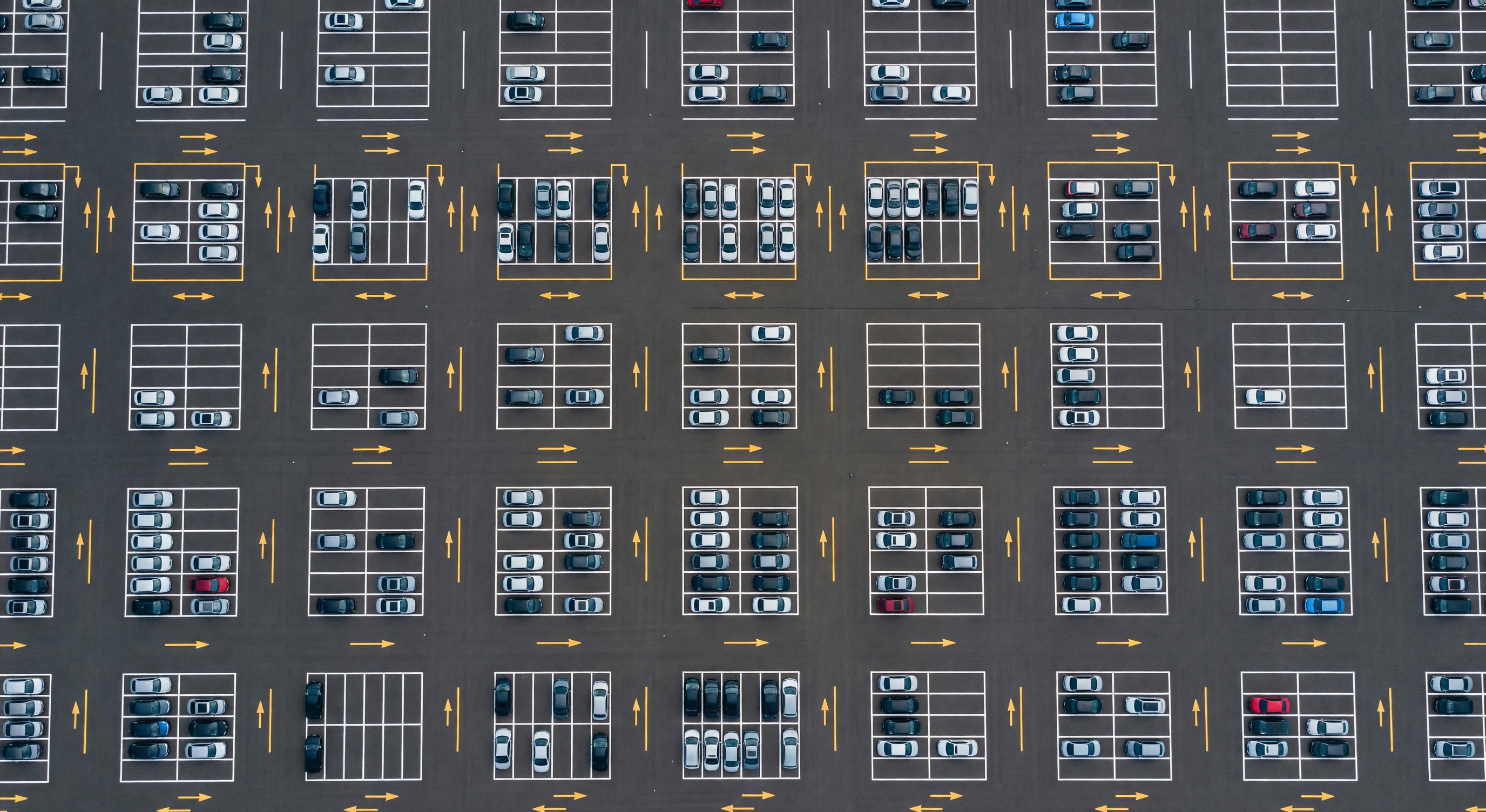 Aerial view of a well-organized parking lot with clear aisle markings and stall lines