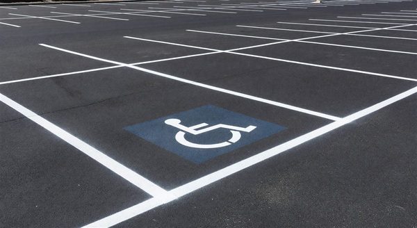 Fresh white parking lot line markings with ADA accessible space markings visible