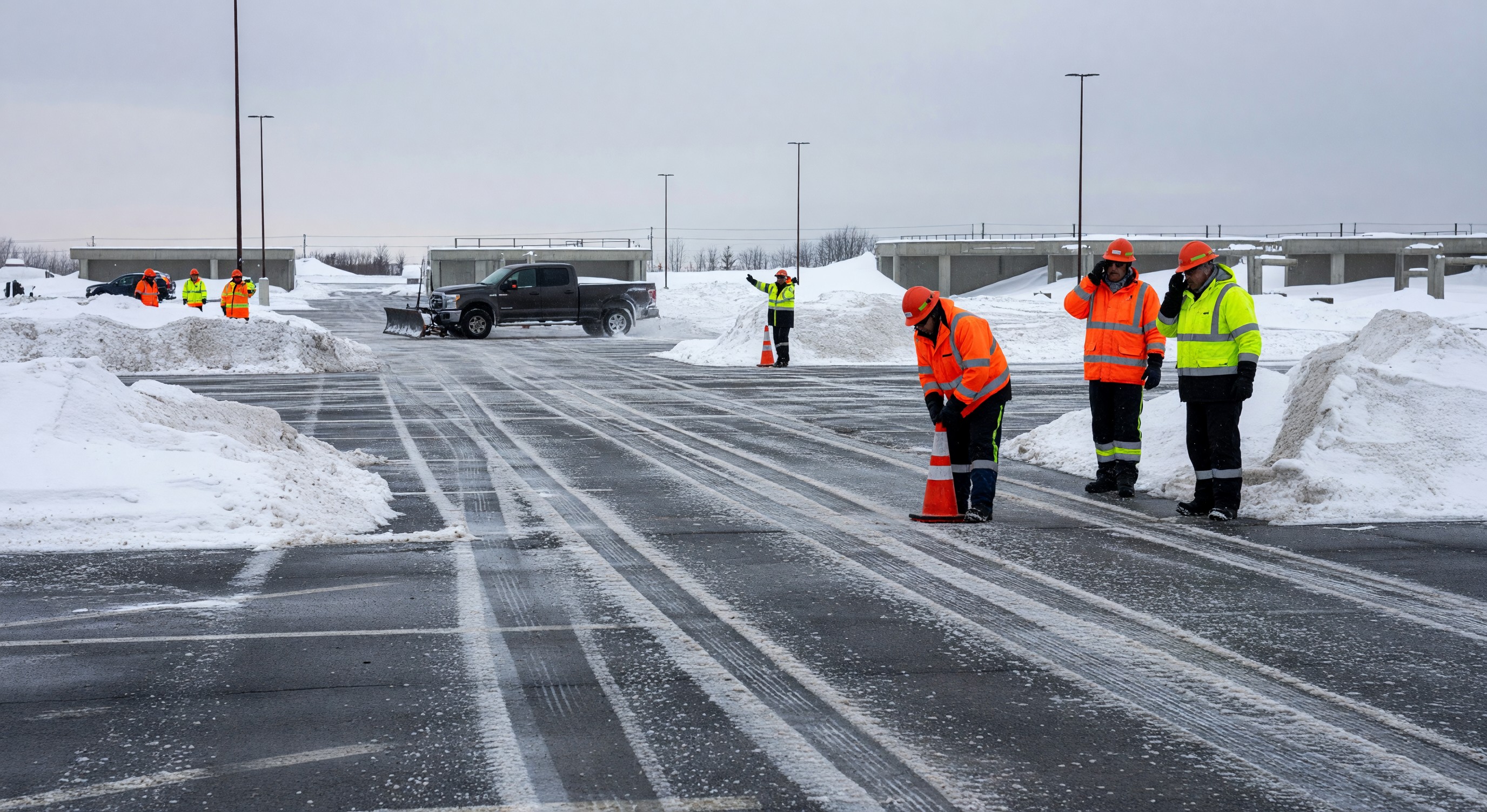 Parking facility cleared of snow in winter with seasonal staff managing the lot