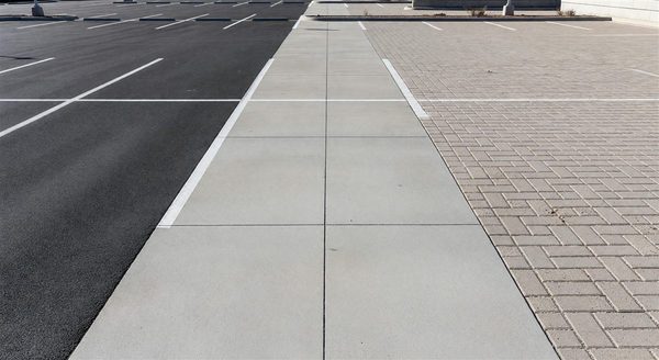 Comparison of asphalt, concrete, and permeable paving surfaces in a parking facility
