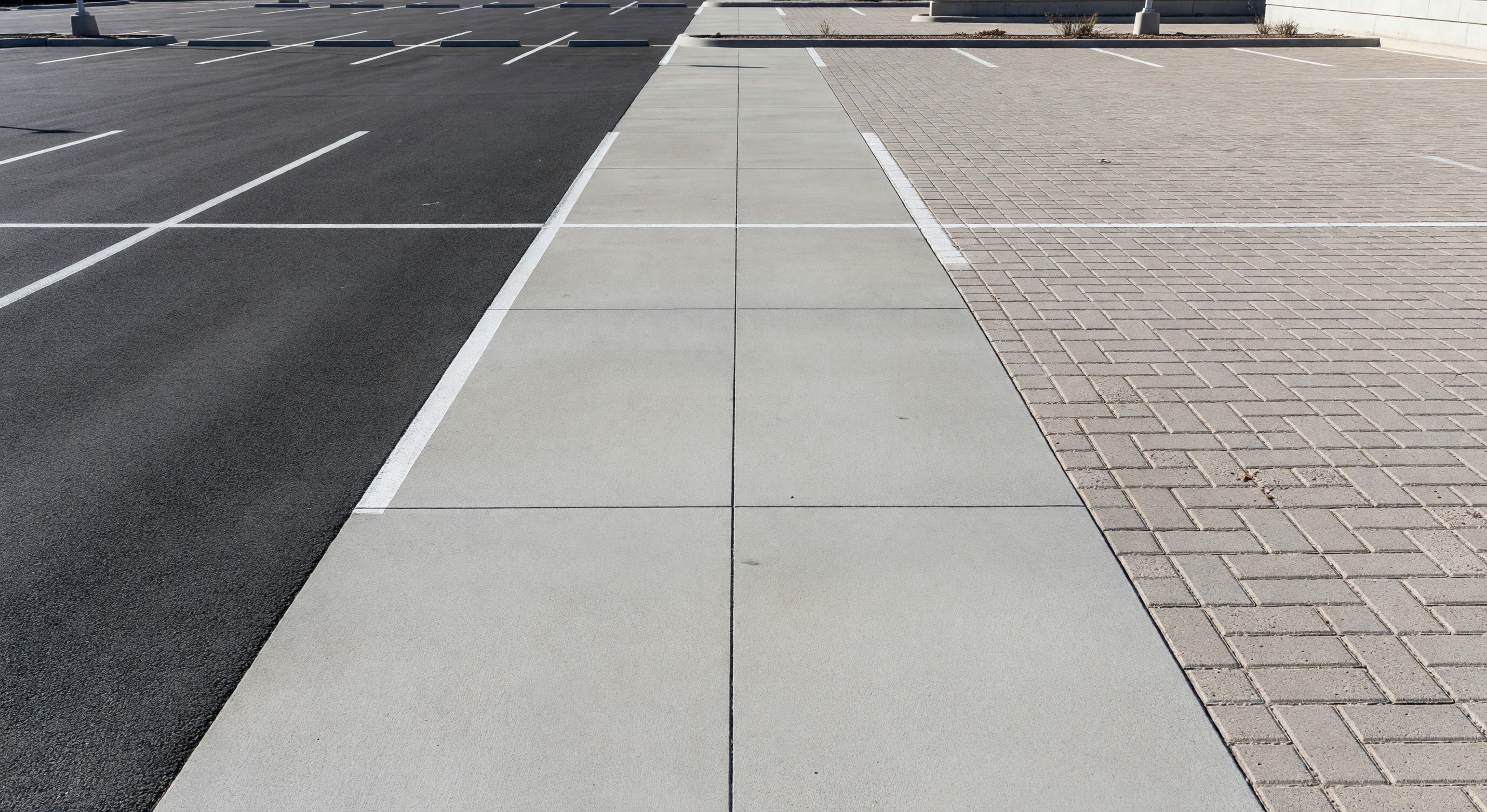 Comparison of asphalt, concrete, and permeable paving surfaces in a parking facility