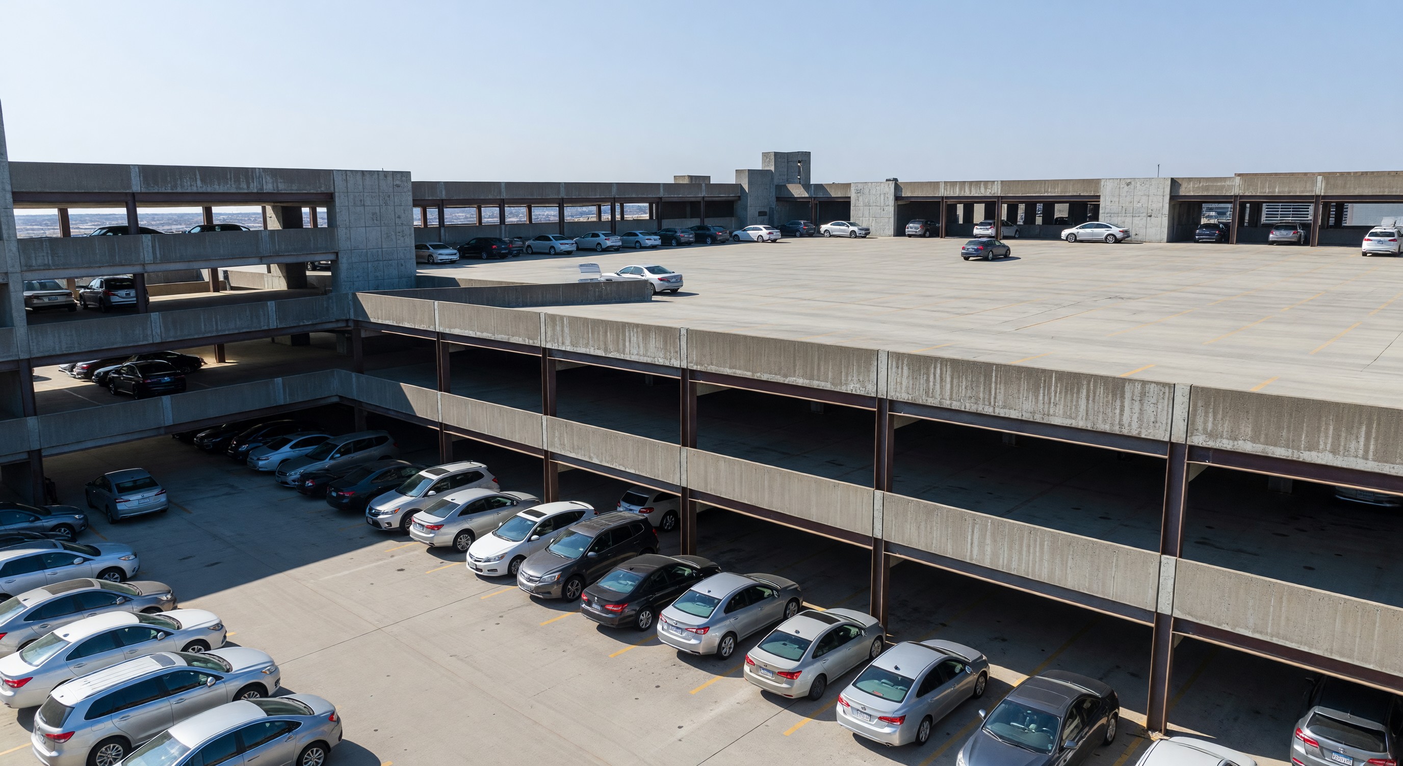 Downtown parking structure with partial occupancy showing impact of hybrid work patterns on weekday demand