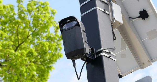 Parking lot with IoT sensors embedded in spaces glowing green and red