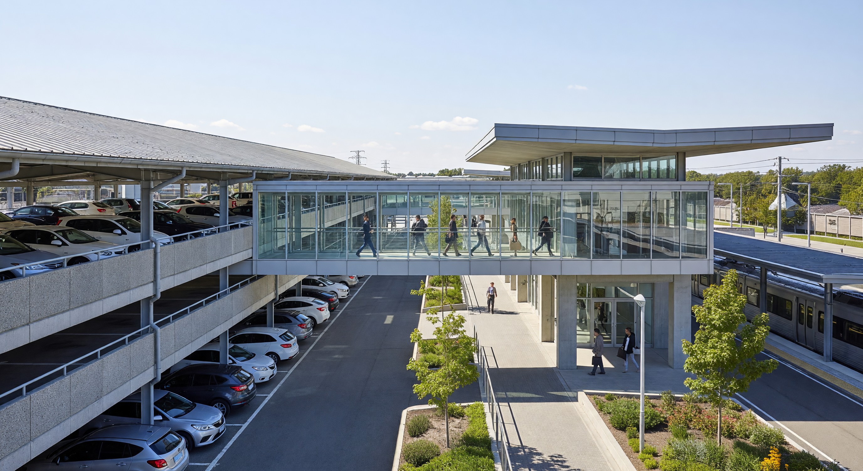 Park-and-ride facility adjacent to a transit station with covered parking and pedestrian connections